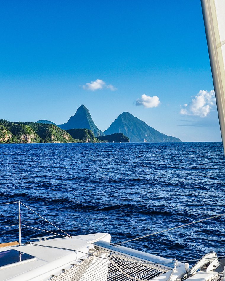 Sailing toward the Pitons across deep blue water.