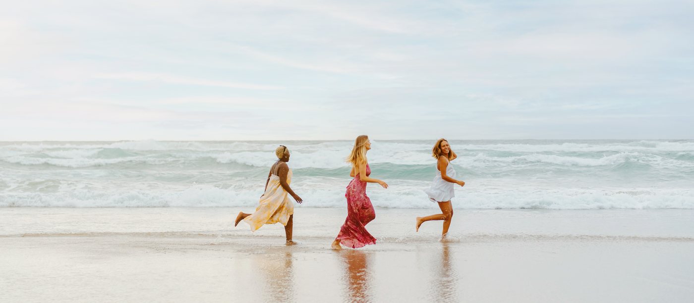 Friends laughing together on a sunny getaway.