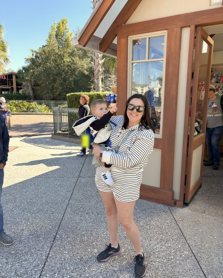 Cydnie holding her youngest son on a sunny walk.