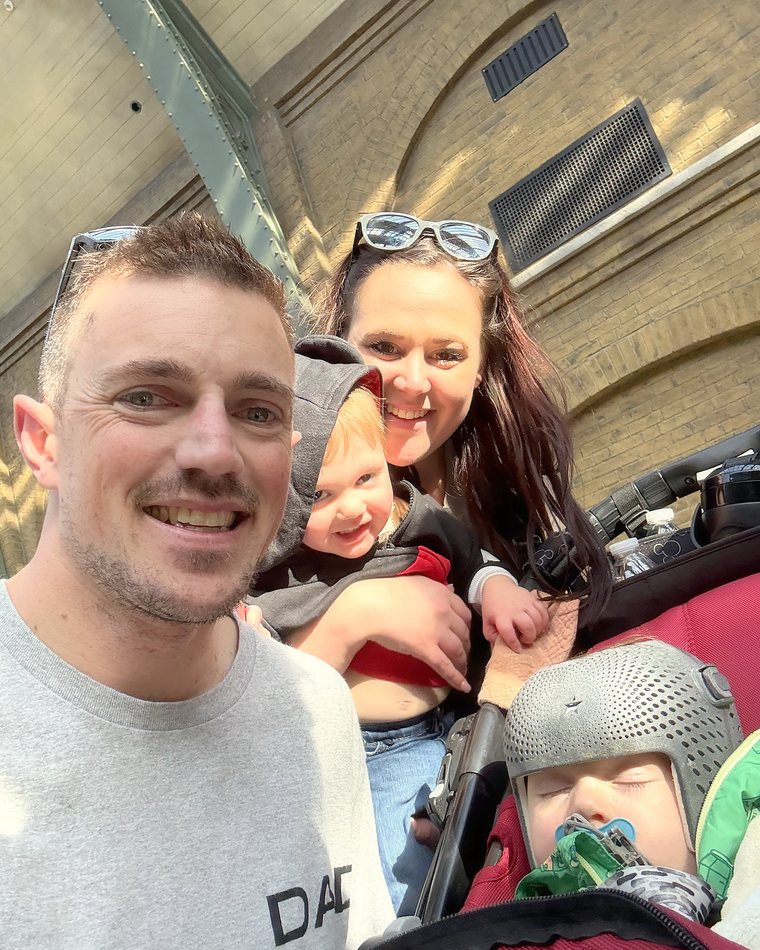 Cydnie, her husband and their two boys in a selfie on a travel day.
