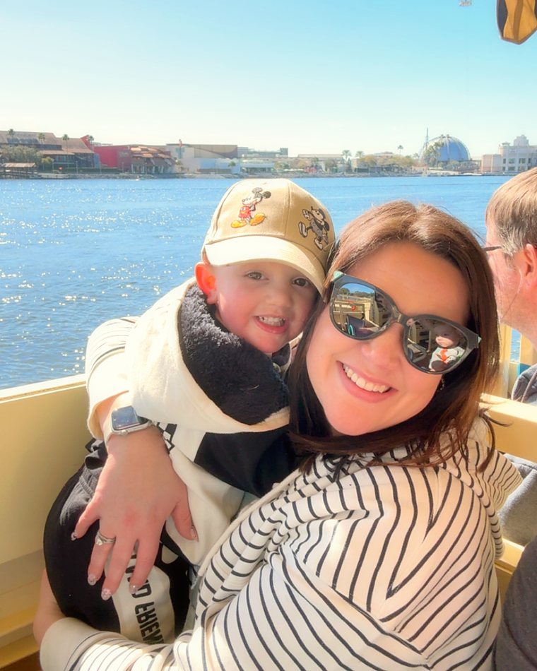 Cydnie's son hugging her on a boat ride on a sunny day.